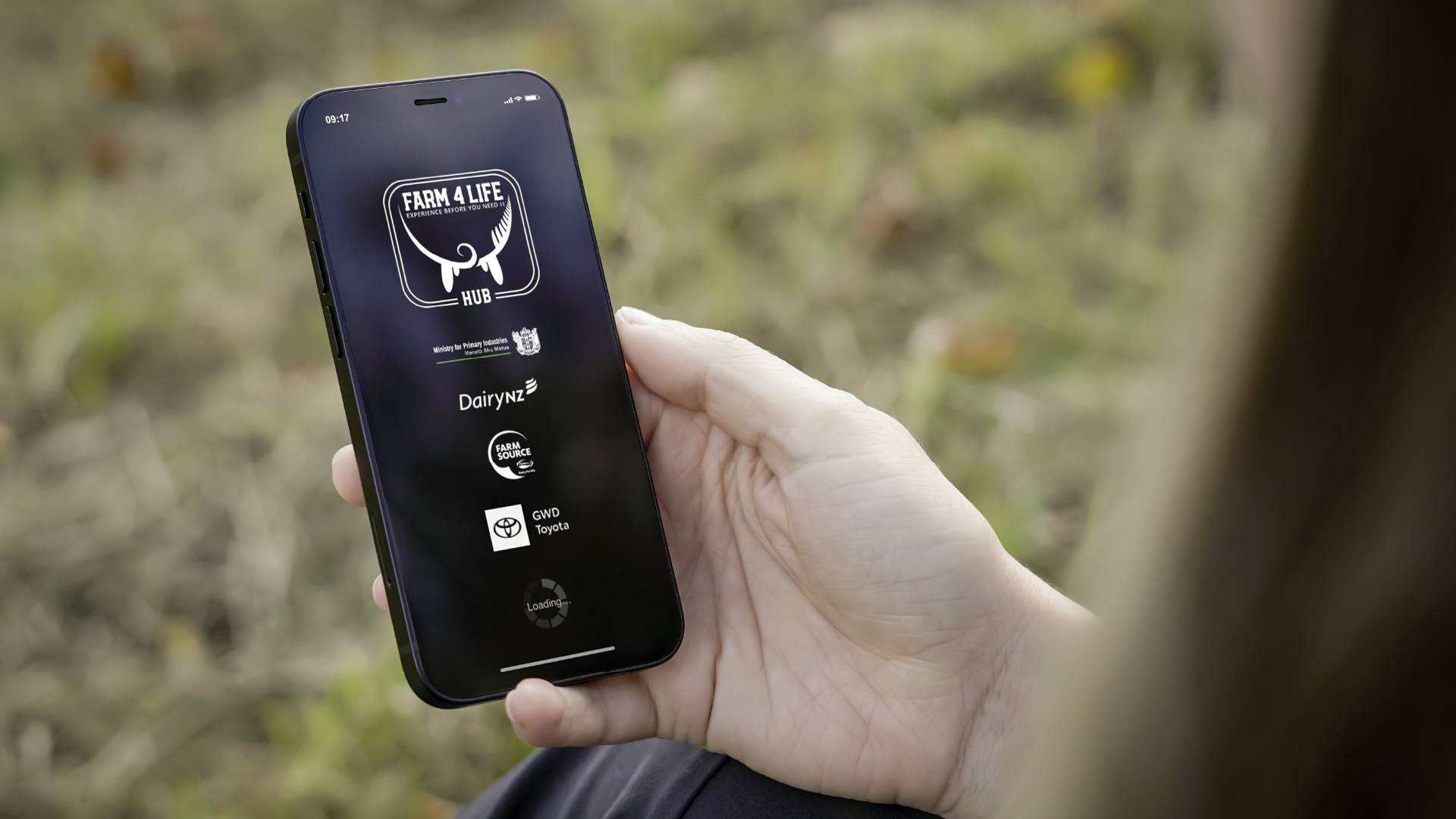 Image Of A Farmer Holding Their Phne With Farm 4 Life App Home Page Opening