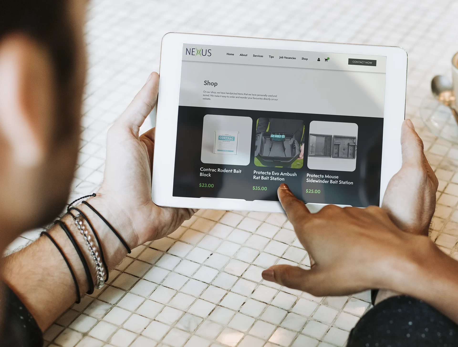 Person Holding A Tablet With Nexus Property Services Website On Screen