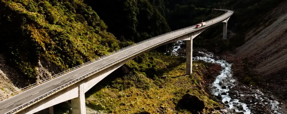 Bridge spanning a lush green valley.
