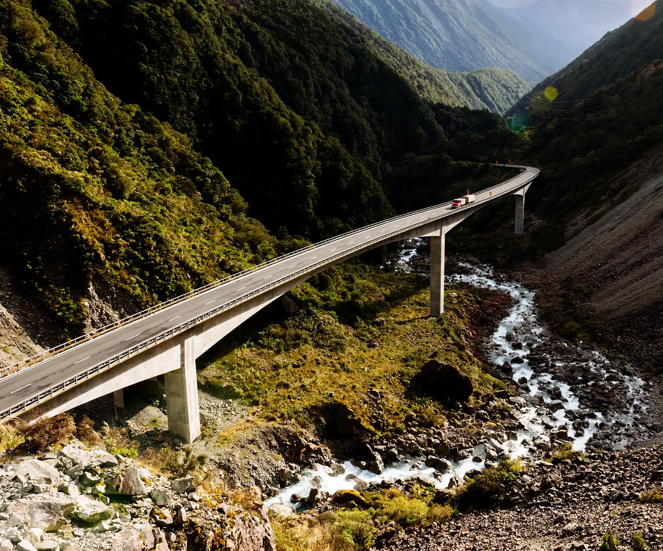 Bridge spanning a lush green valley.